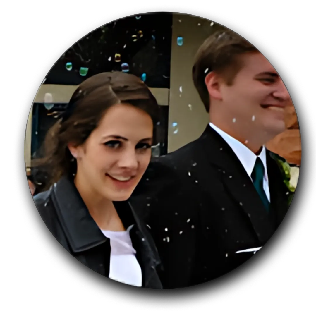  A Women And a Men one in a dark suit, and the other in a black jacket.
