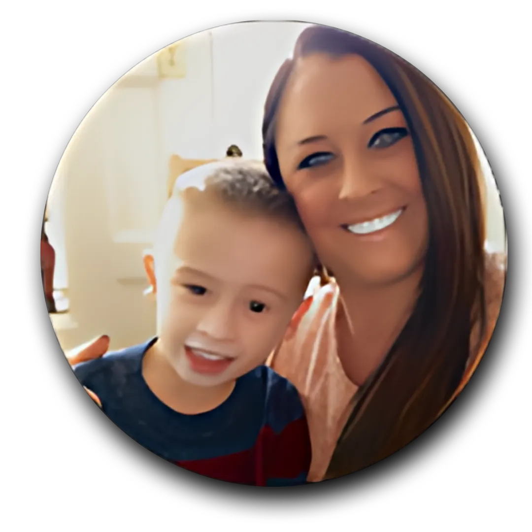 A woman and a child indoors, with the child wearing a blue and red shirt.
