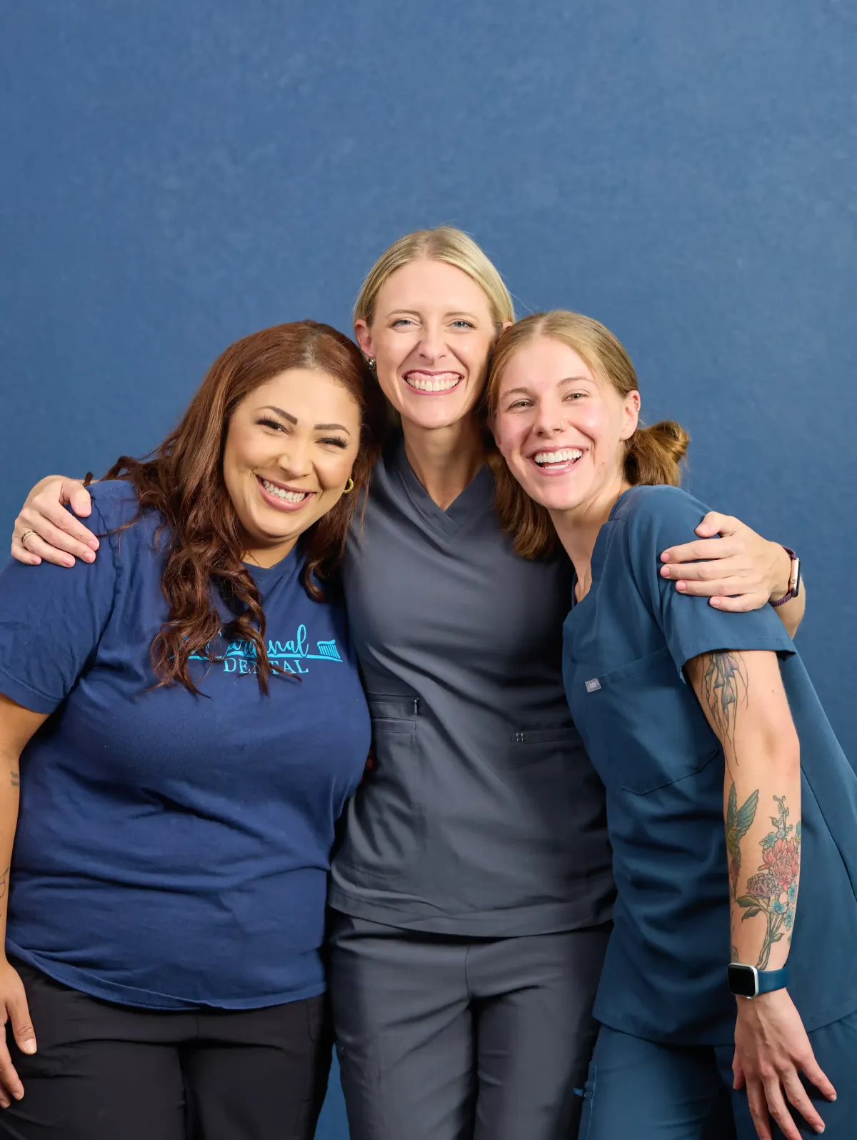 The friendly staff at Cardinal Dental of St. Peters sharing a hug and some smiles