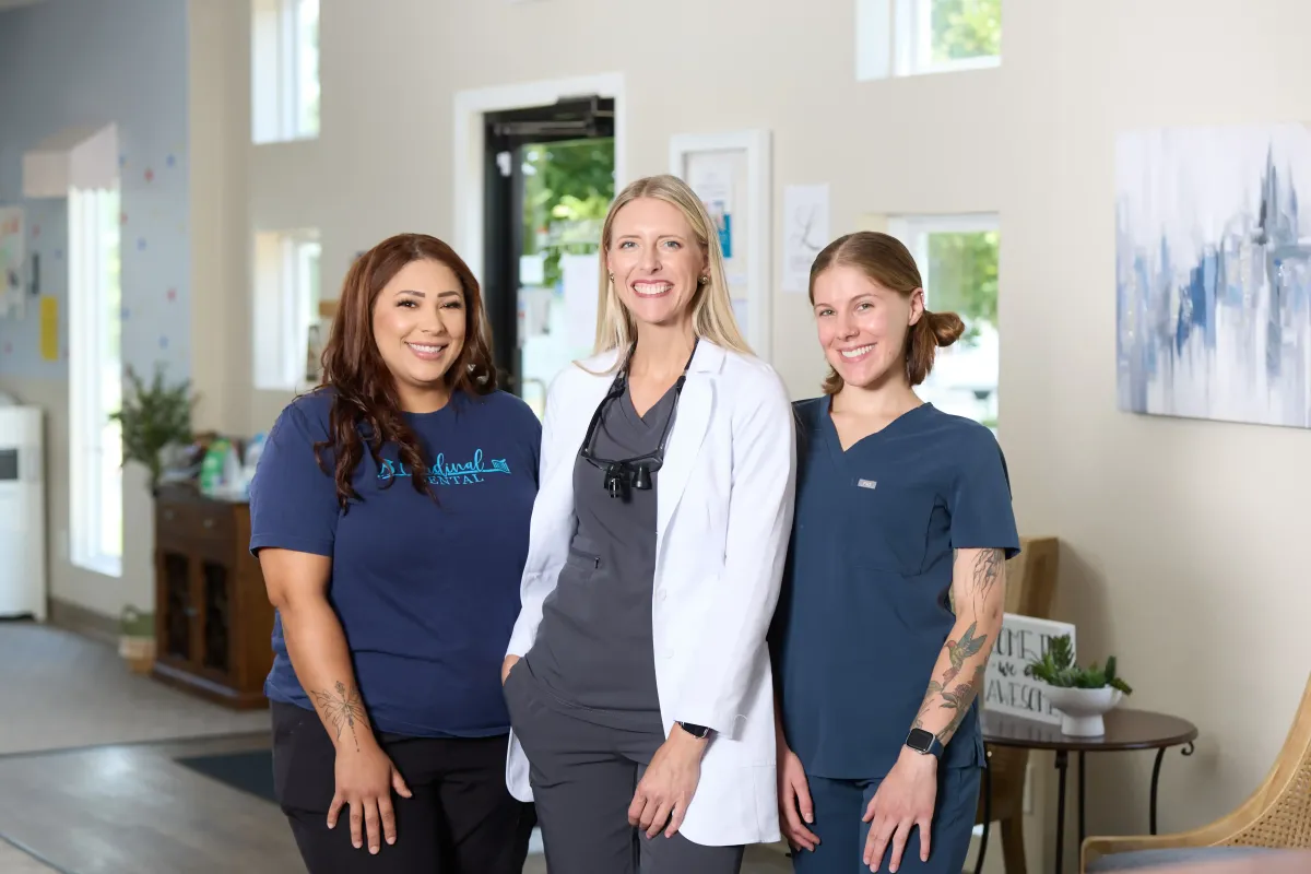 The Cardinal Dental team, led by Cyndi Blalock, with warm smiles ready to serve patients at their St. Peter office