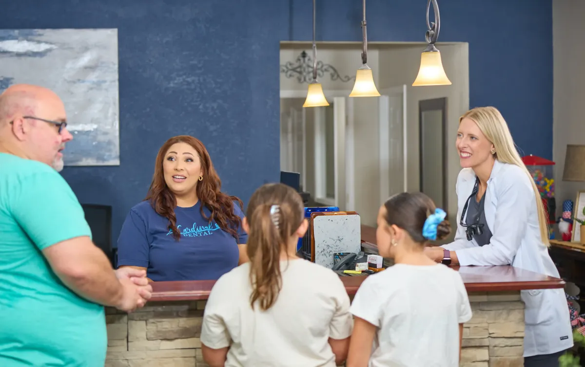 Helpful and friendly dental office staff greeting a patient at Cardinal Dental St. Peters MO