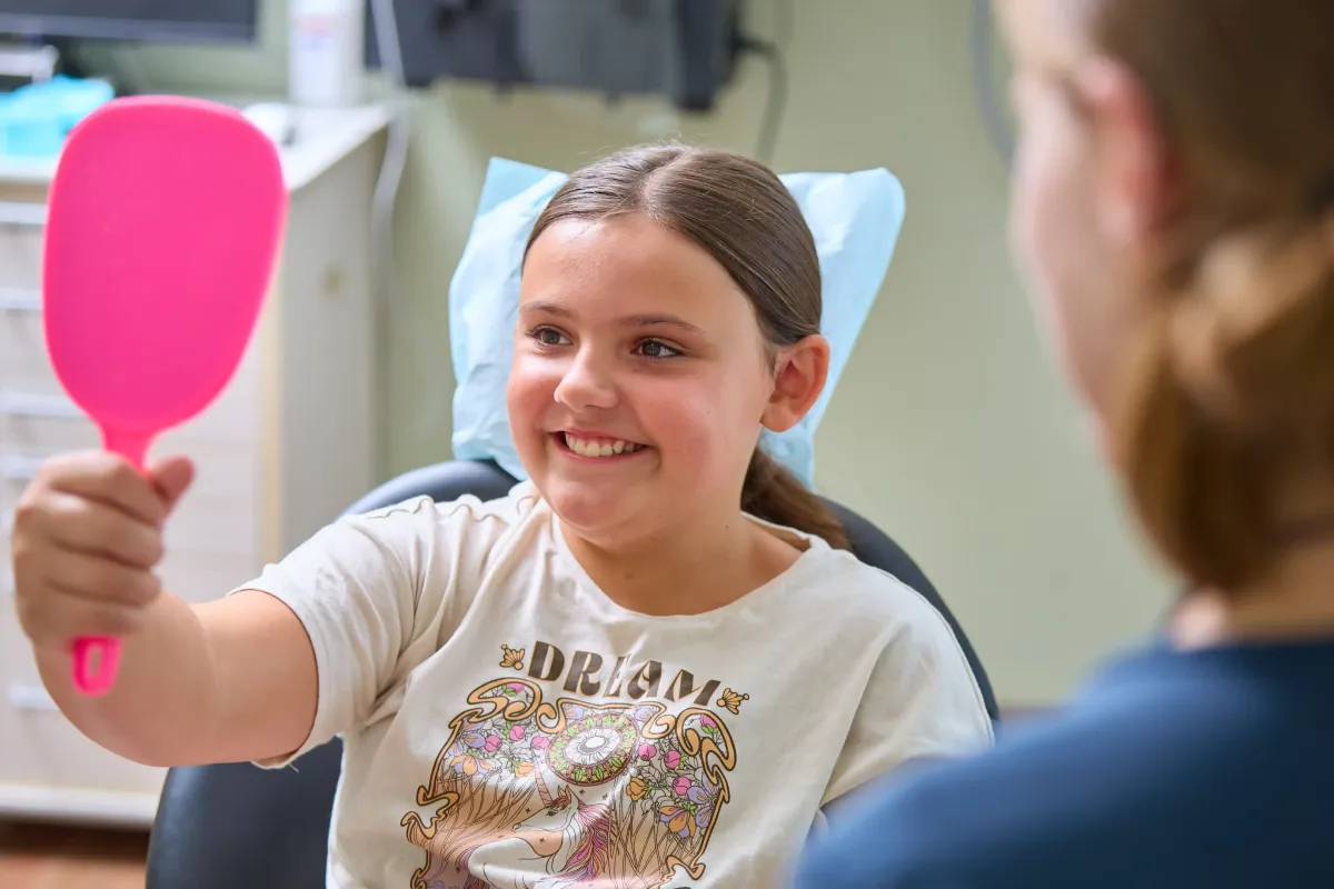 A young patient smiling during a pediatric dental visit at our St. Peters office