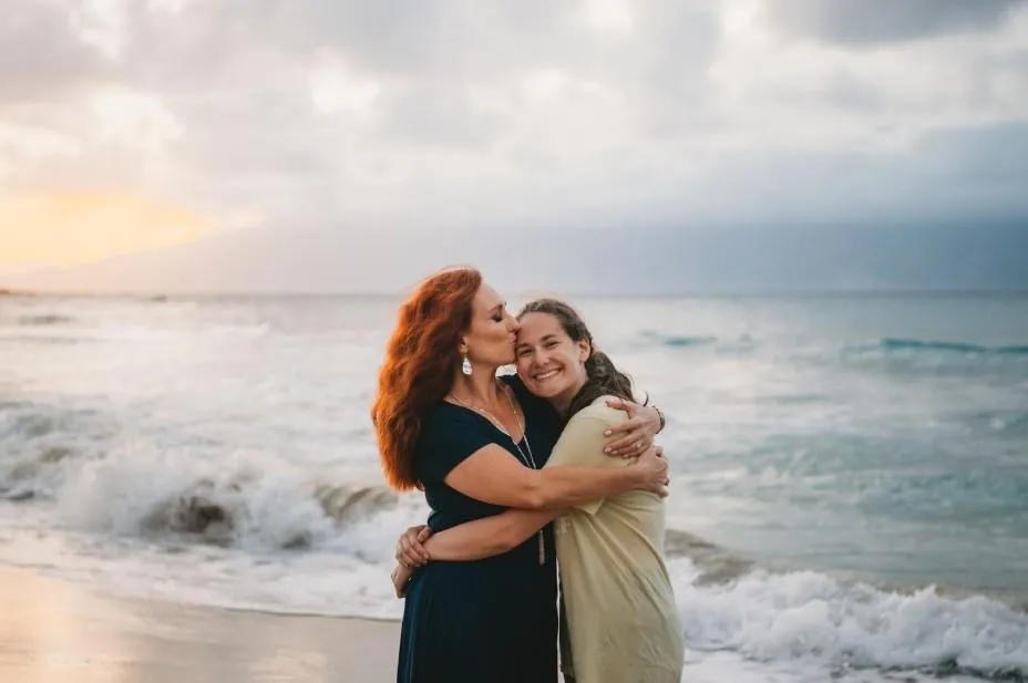 Allyson and her daughter Peyton enjoying time in the ocean, representing work-life harmony and faith-based prosperity coaching values