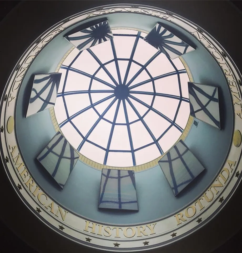 Upward view of the American History Rotunda dome in the Buffalo Pacific prototype, showcasing intricate federalist-style architecture with a glass skylight and surrounding historical display panels.