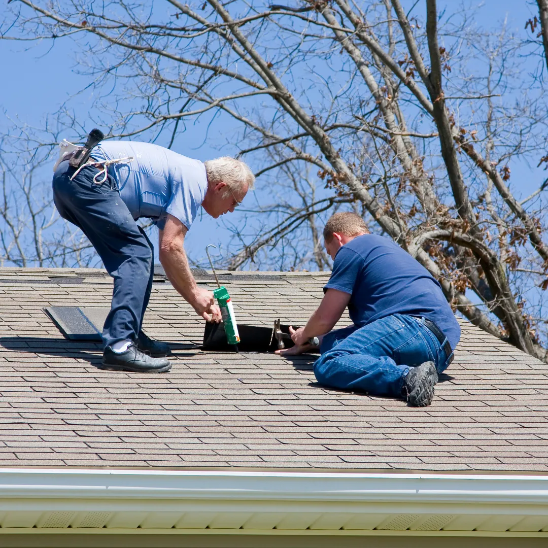 two men doing a roof repair