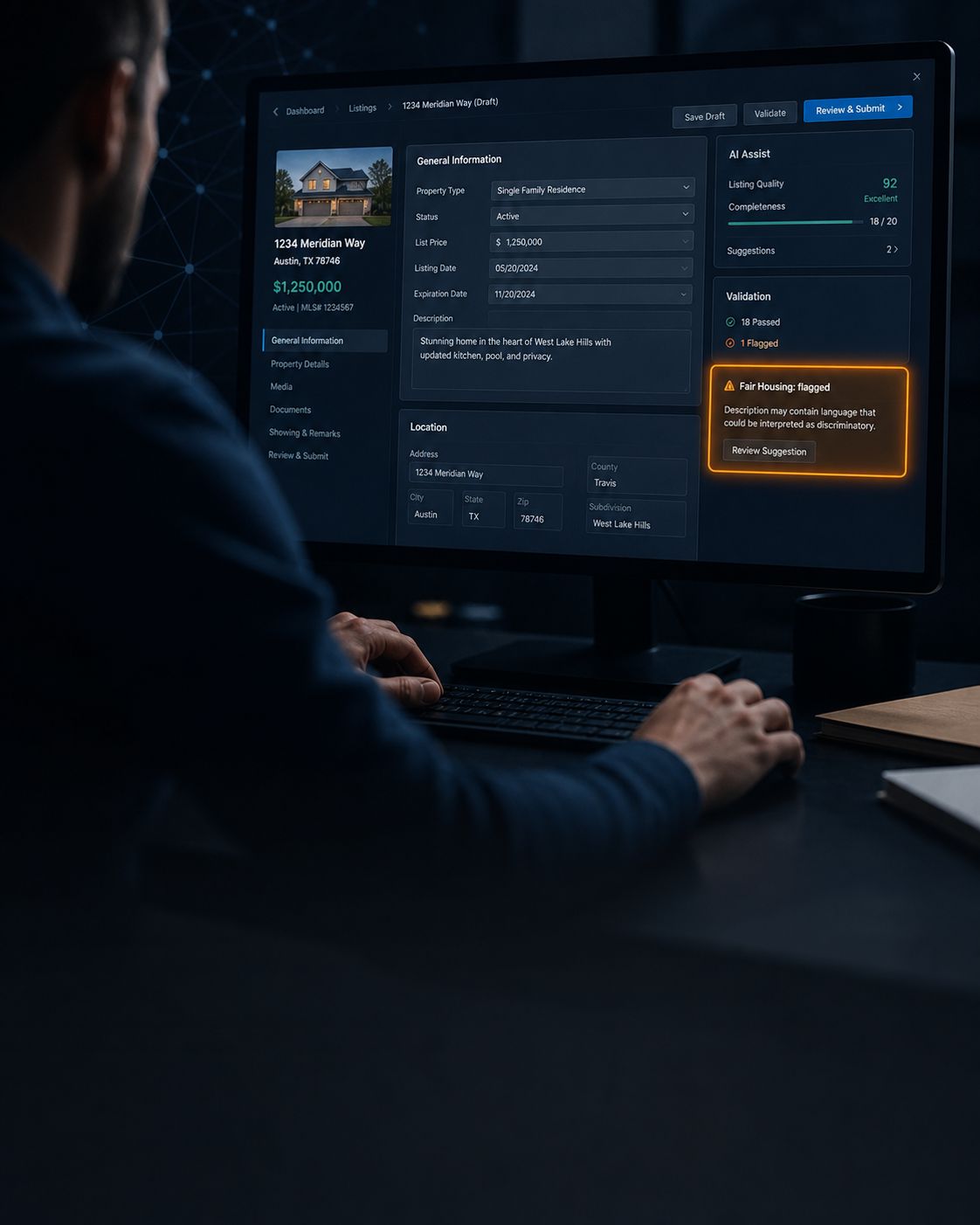 over the shoulder of a listing agents hands and a crisp monitor showing an MLS listing draft with one highlighted Fair Housing flagged