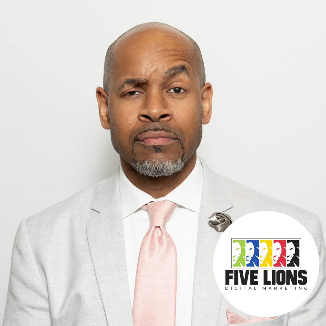 A professional portrait of a marketing consultant in business attire, smiling confidently in a modern Frederick office with local artwork and plants. The setting is warm and approachable, reflecting expertise and a personal connection to the Frederick community.
