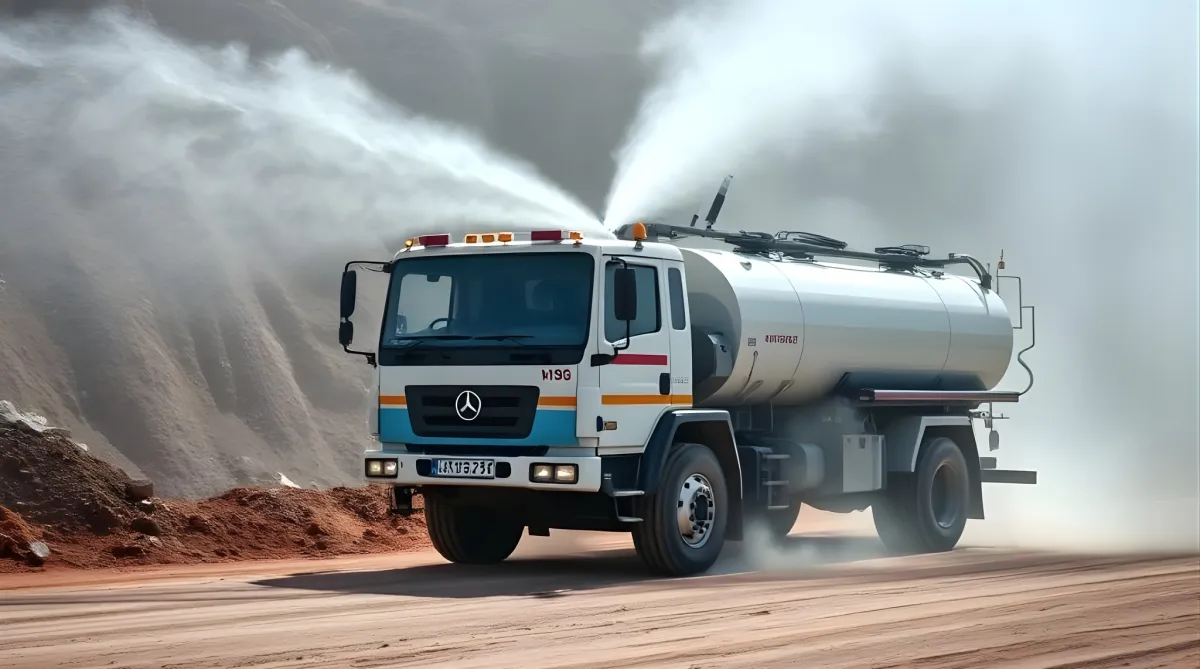 Water tanker spraying water on a dusty construction road.