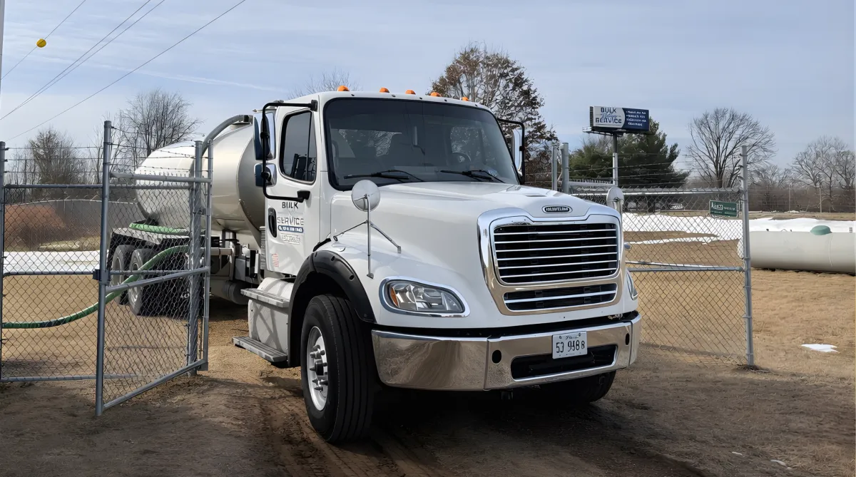 Trailer labeled “Emergency Water Supply” parked near a building.
