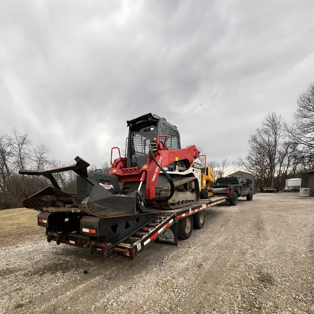 Skid steer stump grinder attachment at work