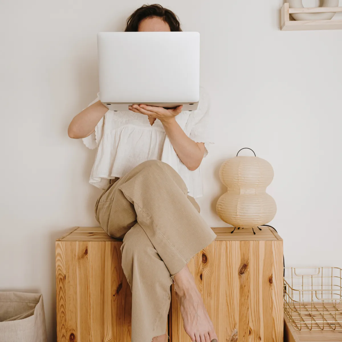 Woman sitting holding a laptop 