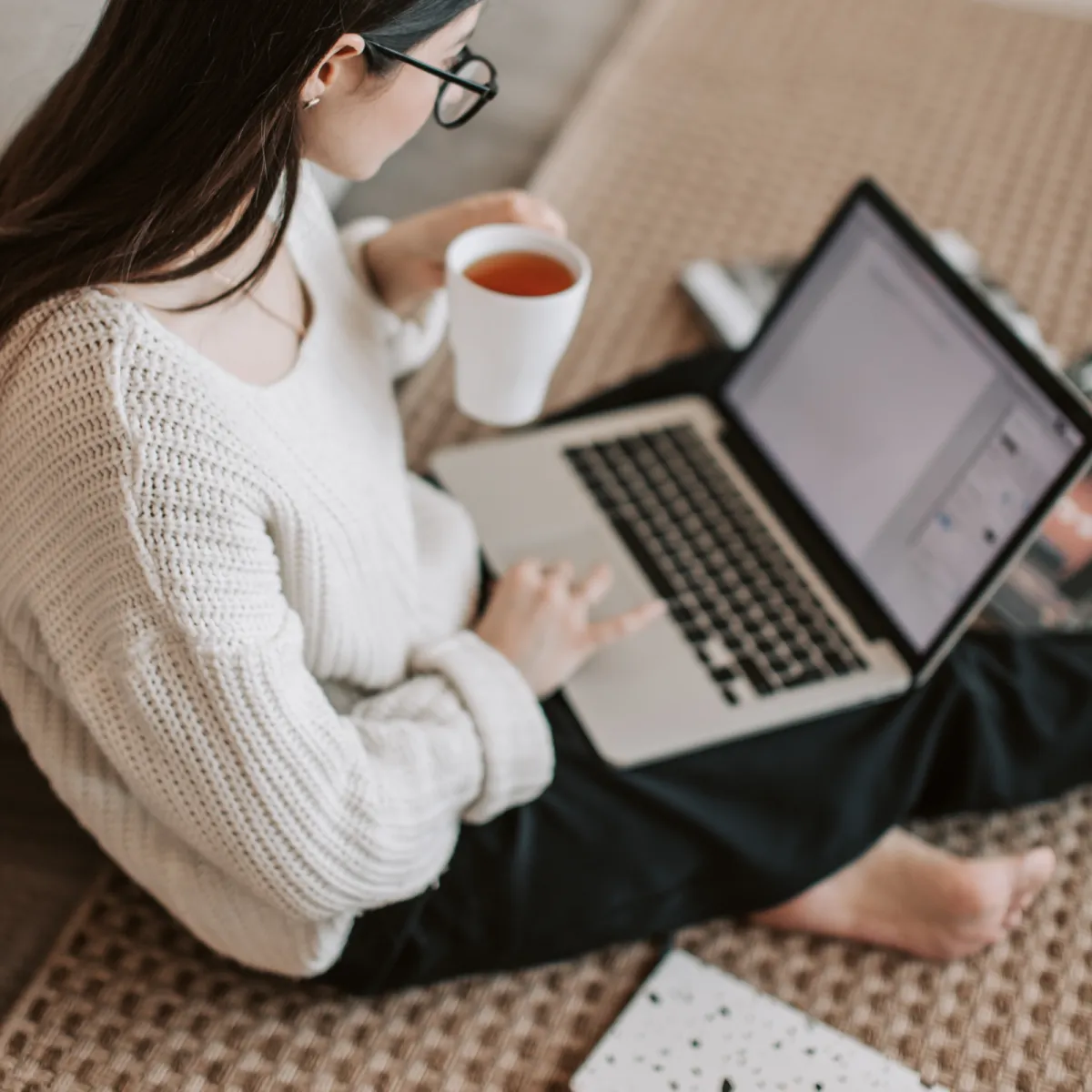Woman sitting holding a laptop 