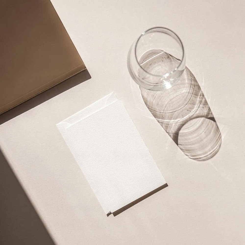 Desktop with paper, portfolio, and water glass