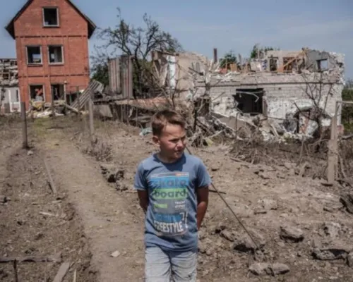 Сhild near a destroyed house