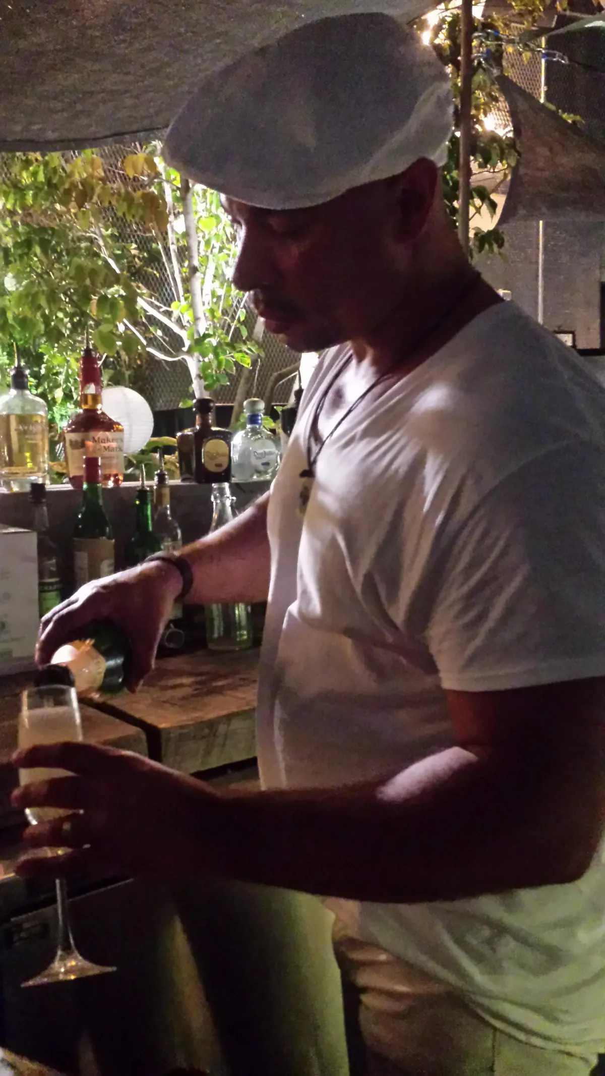Mobile bartenders serving signature cocktails at outdoor wedding