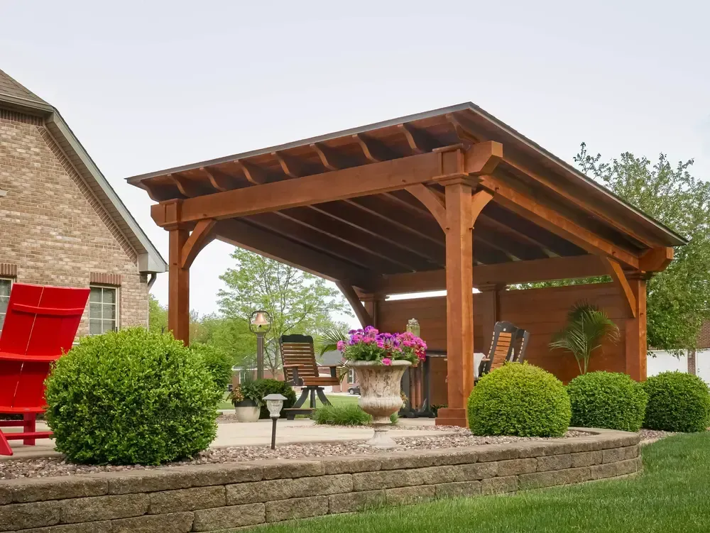 Timber-framed pavilion covering an outdoor living room with seating
