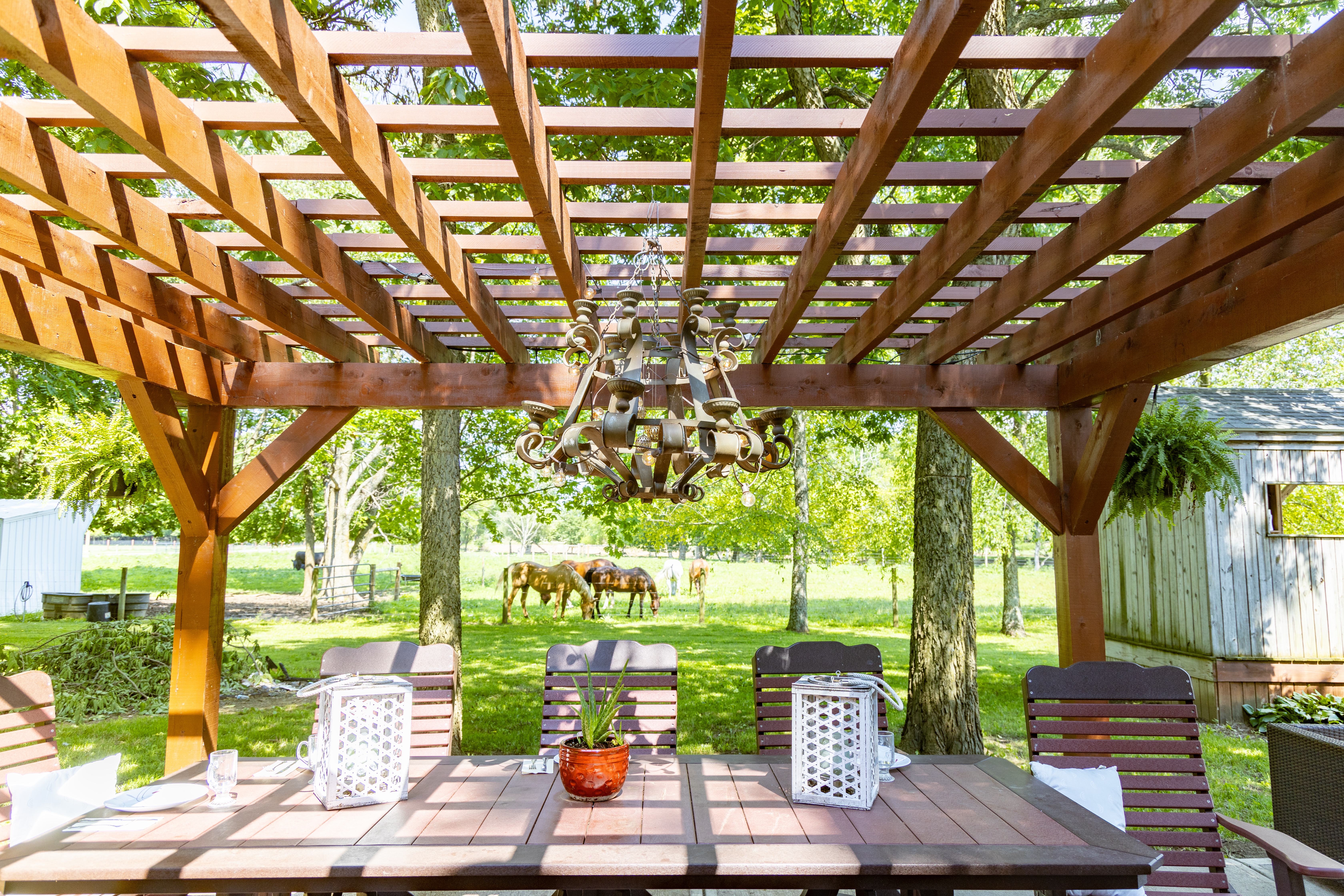 Custom timber-framed pergola built onto a Northern Michigan patio
