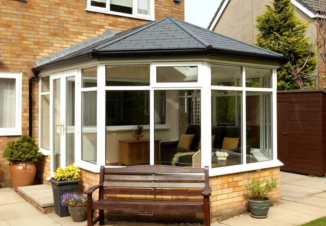 After: A transformed conservatory with a beautifully tiled roof, creating a remarkable difference in comfort, aesthetics, and functionality. The addition of the tiled conservatory roof has significantly improved the space, making it a haven for relaxation and enjoyment throughout the year.