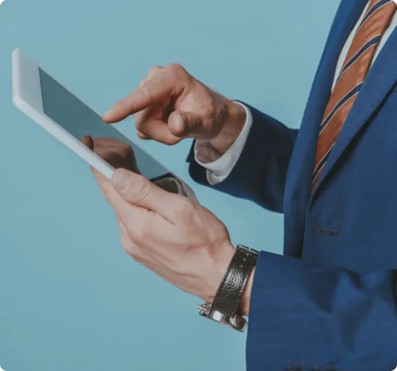Business professional in a suit using a digital tablet for work.