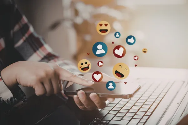 Business owner planning social media content with notebook and laptop on desk