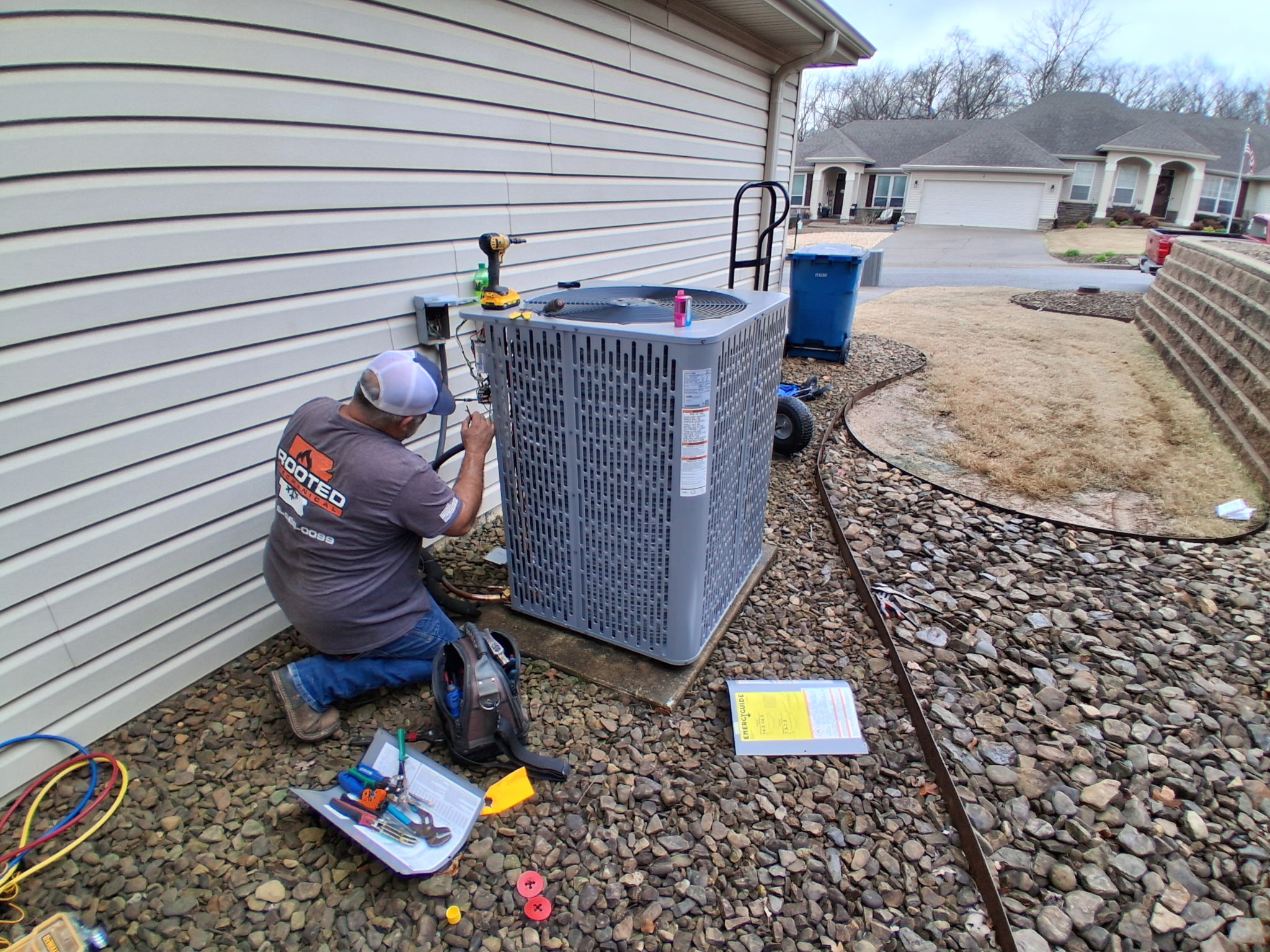 technician checking condensor in Northwest Arkansas home