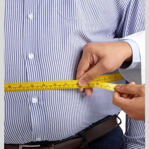 man with excess body fat getting measured