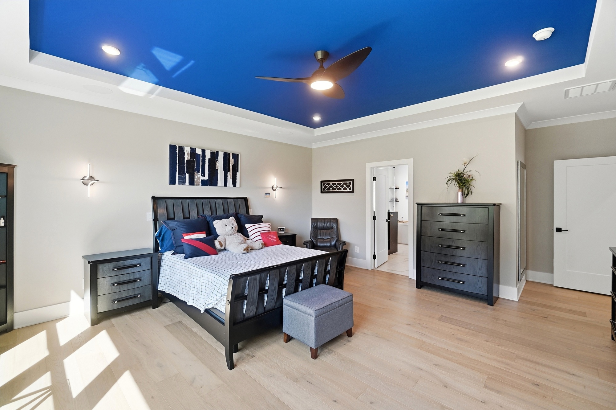 Luxurious primary bedroom suite with natural light
