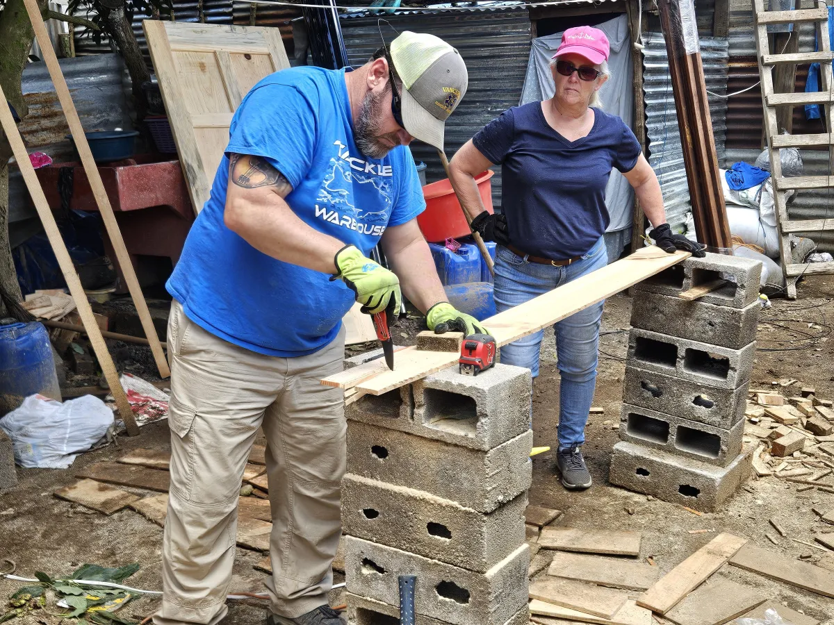 man standing infront of miter saw