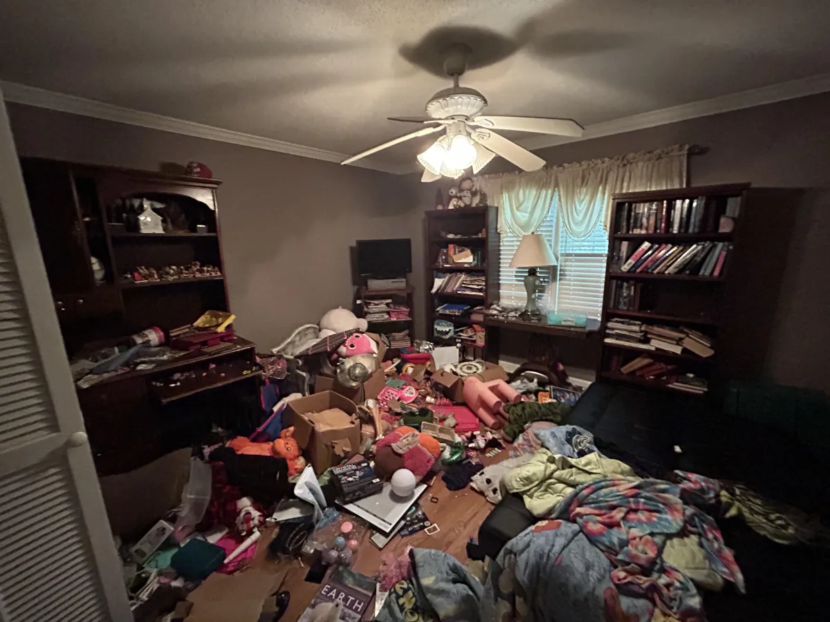 a tall building sitting next to a forest of trees