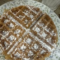 Stack of pancakes with berries and syrup