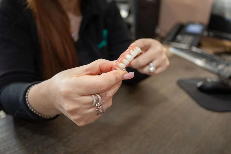 woman in black tank top holding white textile