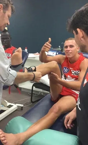 Craig J Hubbard fitting AFL Sydney Swans football playing with a KiSS X Ankle Self-Rehab Safety System after receiving a grade 3 ankle sprain and trying other ankle braces and tape methods for ankle sprains in the past