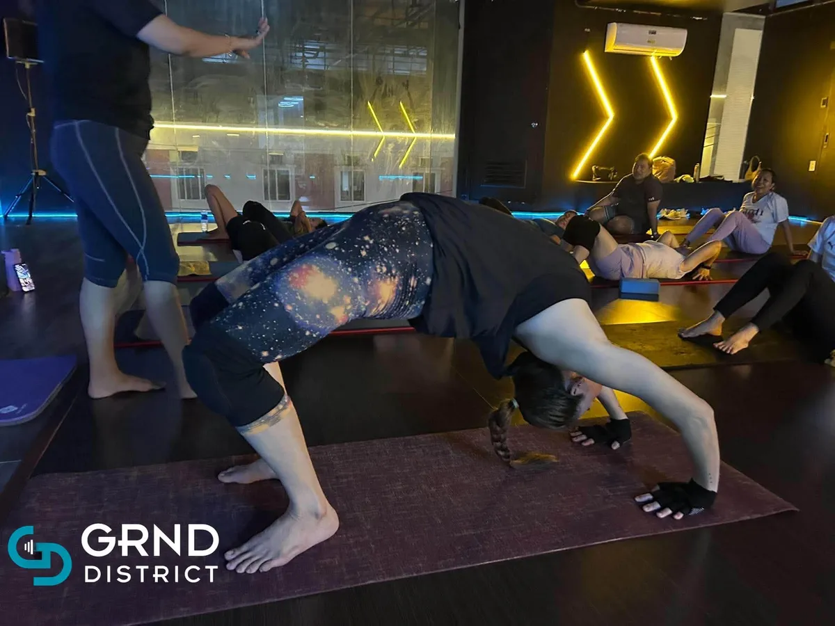 Member stretching in the GRND District studio
