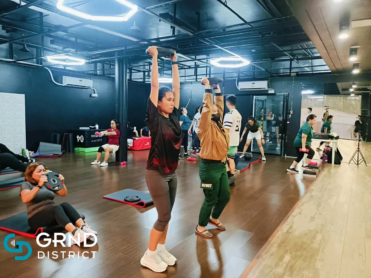 Coach leading a dance fitness class at GRND District Fitness Gym