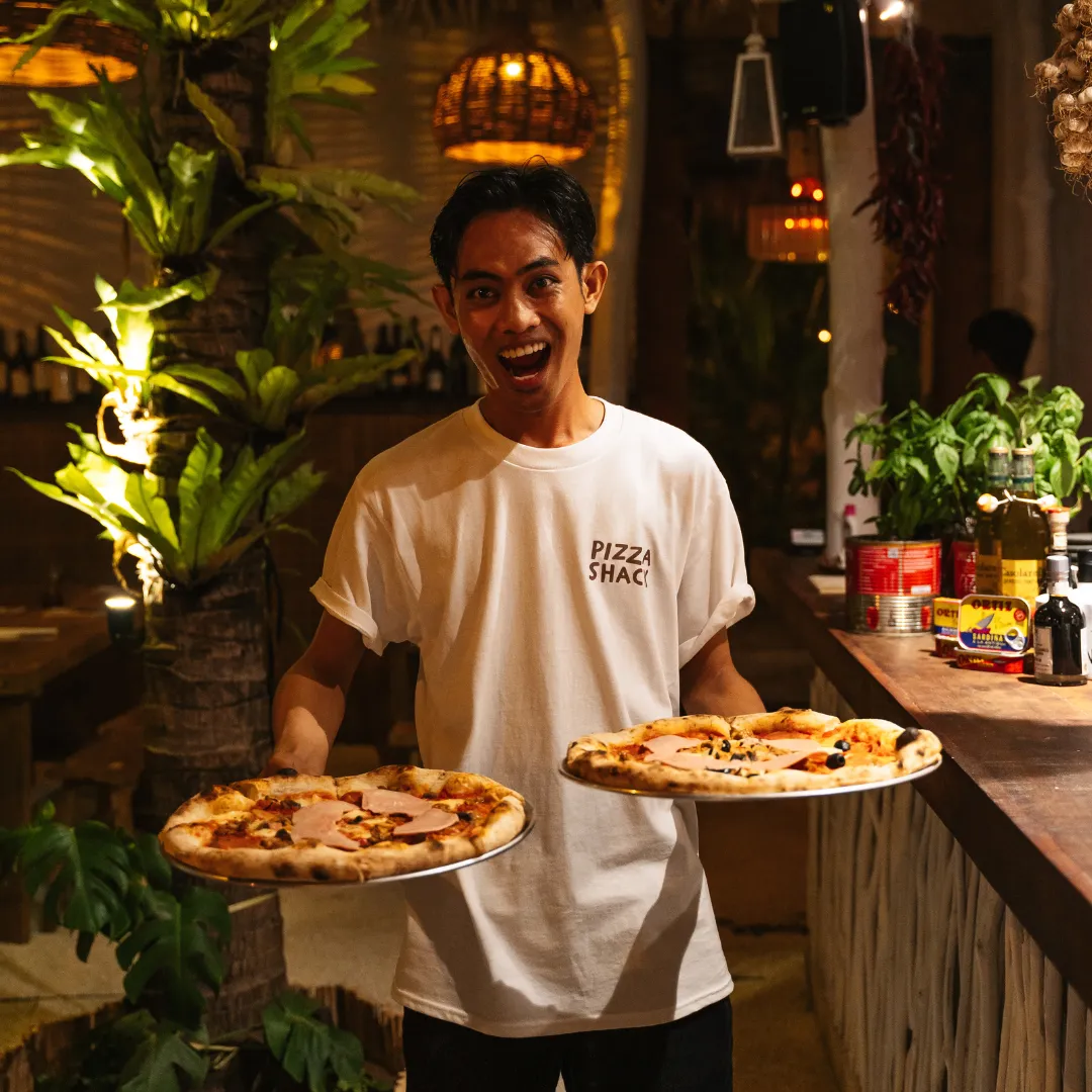 pizza shack lombok crew serving pizza to customer