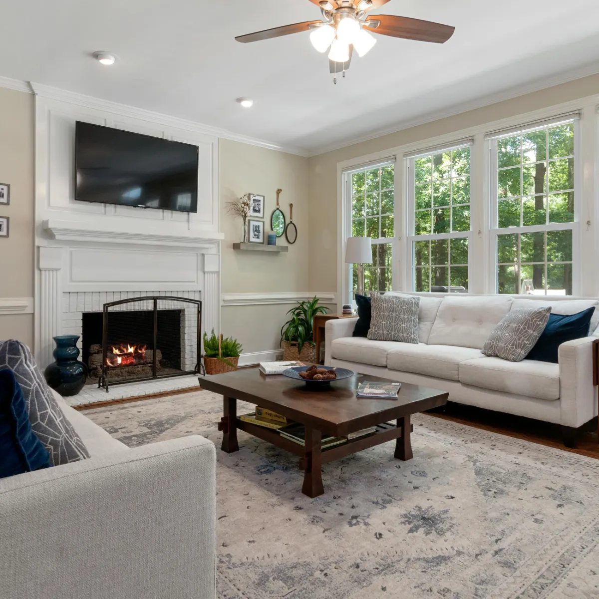 Modern living room remodeling project in Omaha with fireplace, large windows, and updated flooring