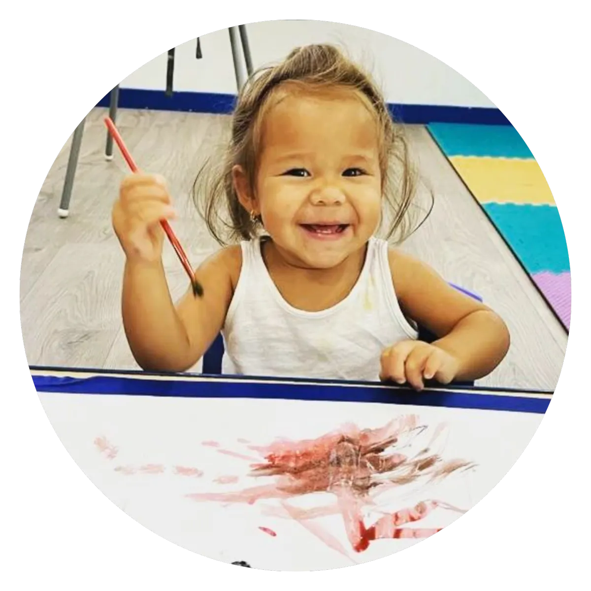 Happy Child in childcare facility painting