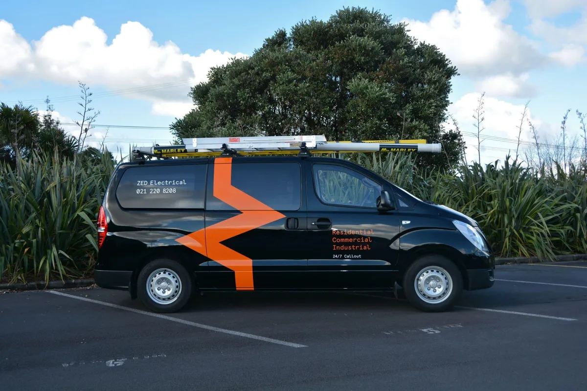 Zed Electrical service van parked in Auckland, showcasing branding and contact details with 24/7 callout for residential, commercial, and industrial electrical work