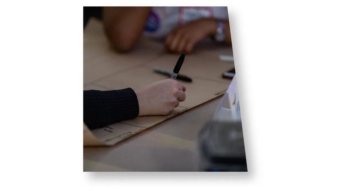 Educator writing with a marker during a hands-on workshop