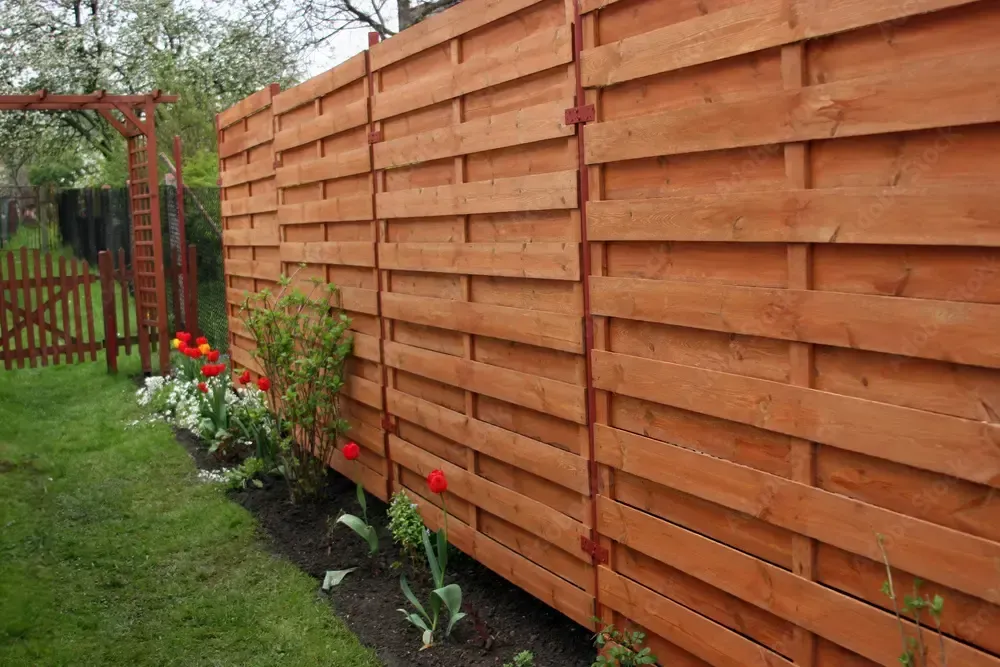 a proud fence builder putting up a fence