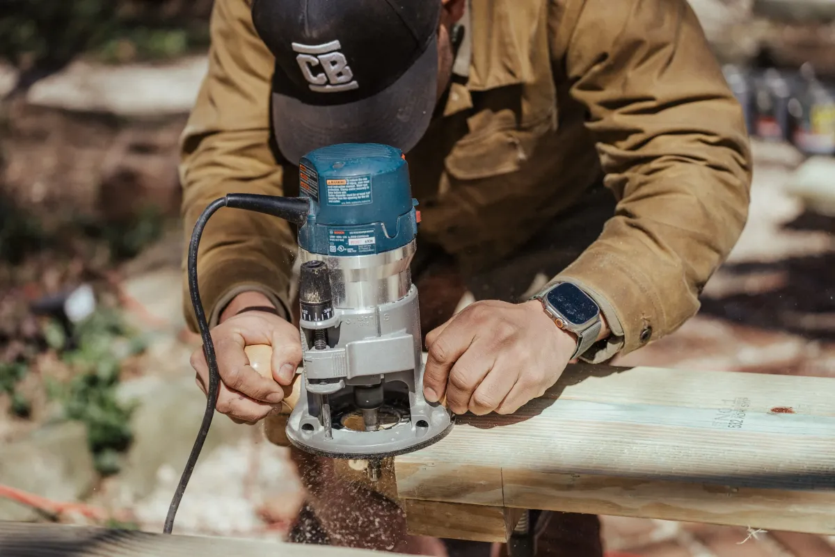 Image of a fence repair expert fixing a damaged picket fence - "Skilled fence repair technician repairing a picket fence."