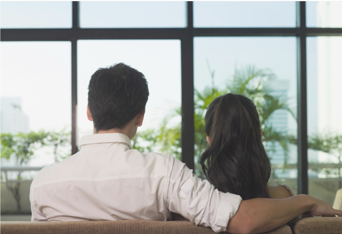 couple sitting back facing window