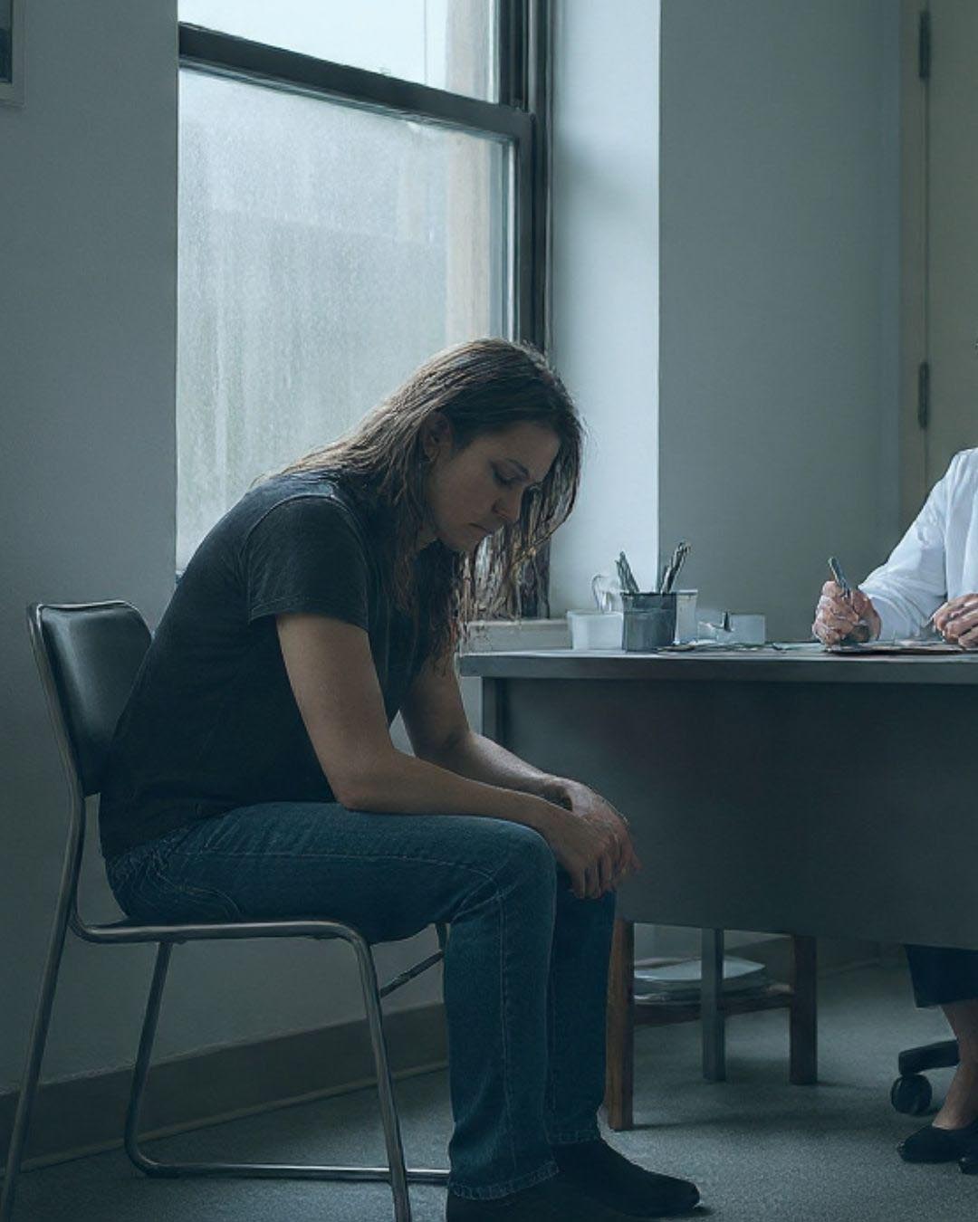Woman stressed in front of a doctor