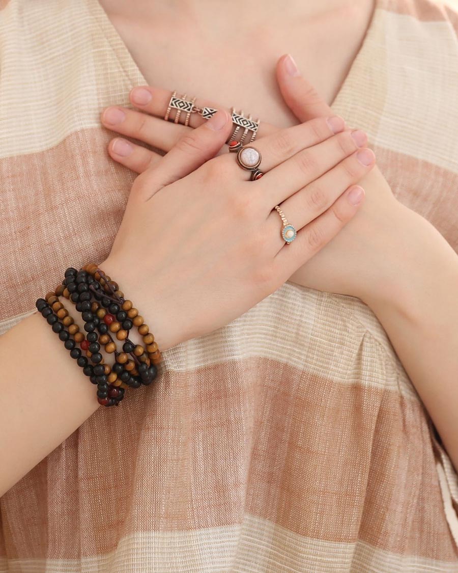 two hands of a woman on her chest