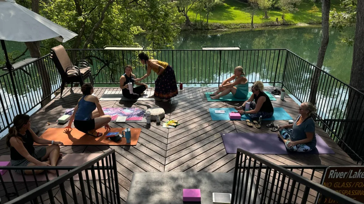 Joyful participants bonding during restorative retreat workshop