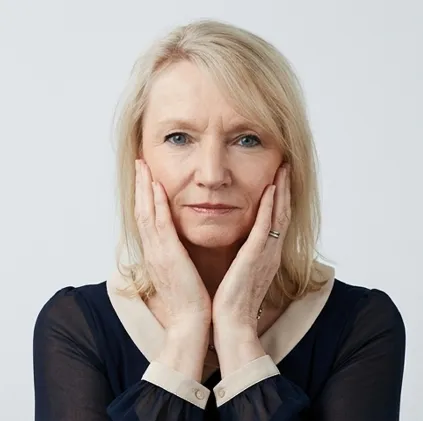 Carol Standing hands on face