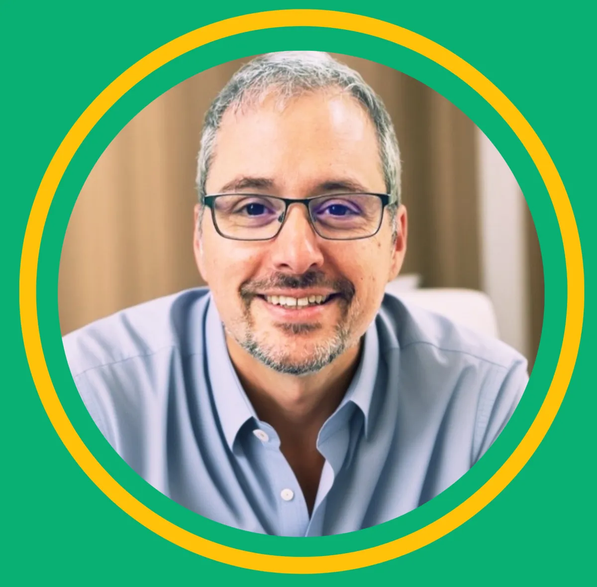 Portrait of Joseph Porto, smiling and wearing a striped sweater, with a green background.