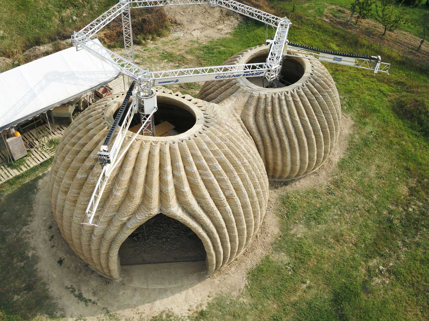 3D-printed earthen structure inspired by regenerative bioconstruction principles, showcasing how locally sourced natural materials and advanced construction technology can create sustainable housing solutions for future ecological communities.
