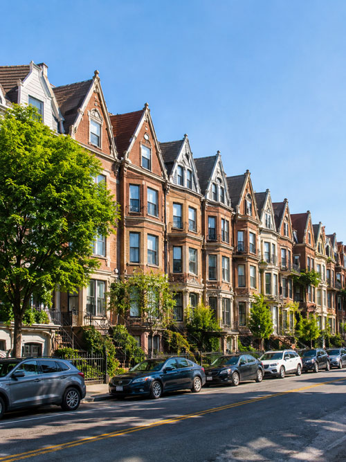 Row of classic brick townhouses typical of New York City neighborhoods