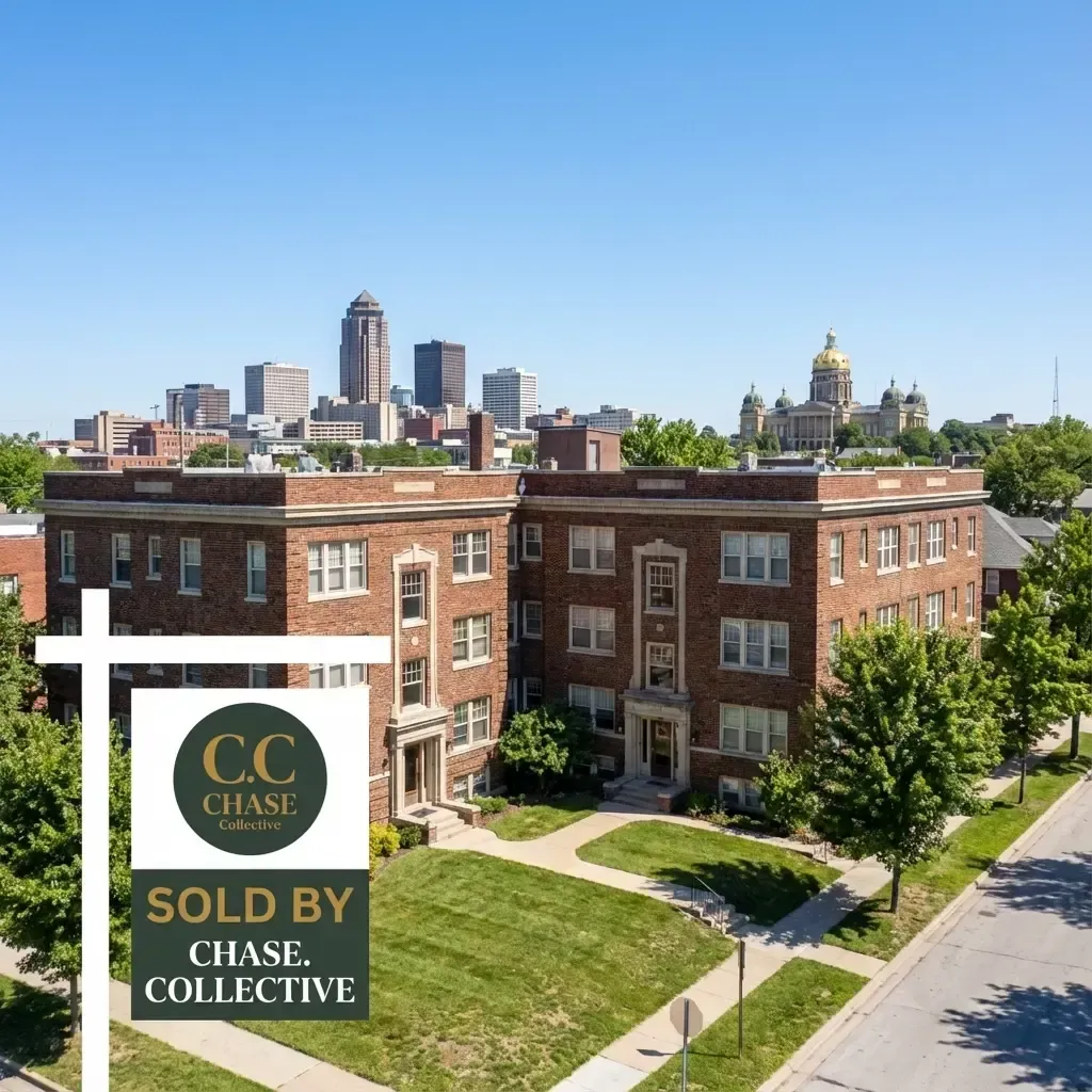 Aerial view of a large multi-unit investment property or apartment building in Des Moines with the downtown skyline in the background, featuring a 'SOLD BY CHASE. Collective' sign.